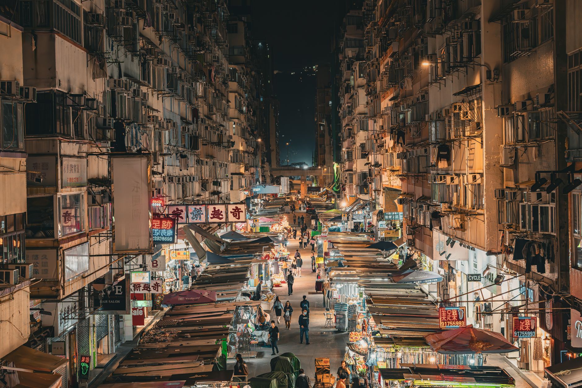 Explore the bustling night market streets of Mong Kok, Hong Kong, illuminated by vivid str